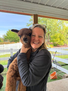 Kerri Harting hugging Gemini, one of Eagle Eye Farm's 2026 baby alpacas